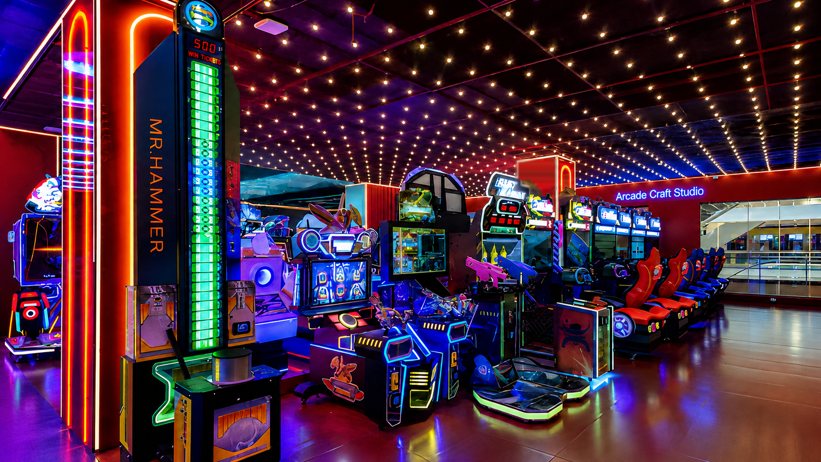 Indoor amusement arcade zone in China with a ticket-redemption hammer tower, a row of racing simulator cabinets, video game machines and children's rides under a starlit LED ceiling; a third-party venue sign has been masked for privacy