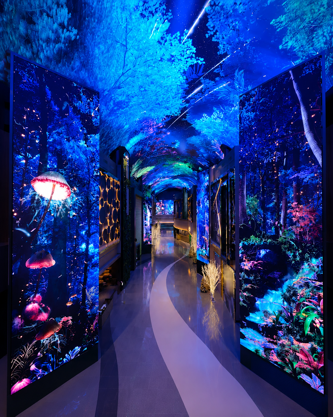 Immersive LED media walkthrough in a mall attraction — a curved corridor lined with tall vertical LED screens showing a glowing bioluminescent forest with pink jellyfish and mushroom shapes, an arched LED ceiling starfield, and a winding illuminated floor path.